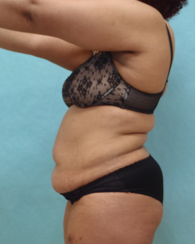 woman posing in front of water