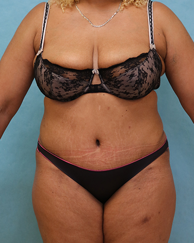 woman posing in front of water